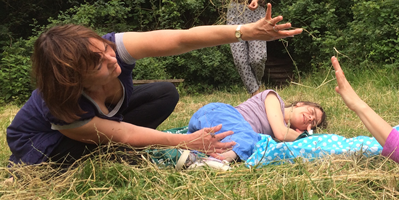 3 women lying on grass