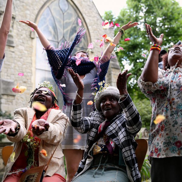 People jumping for joy outdoors.