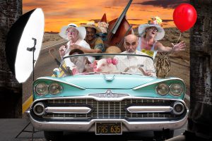 5 elders squeezed into a 1950's roofless car