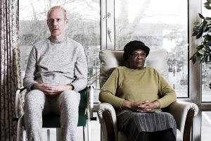man and woman sitting facing camera