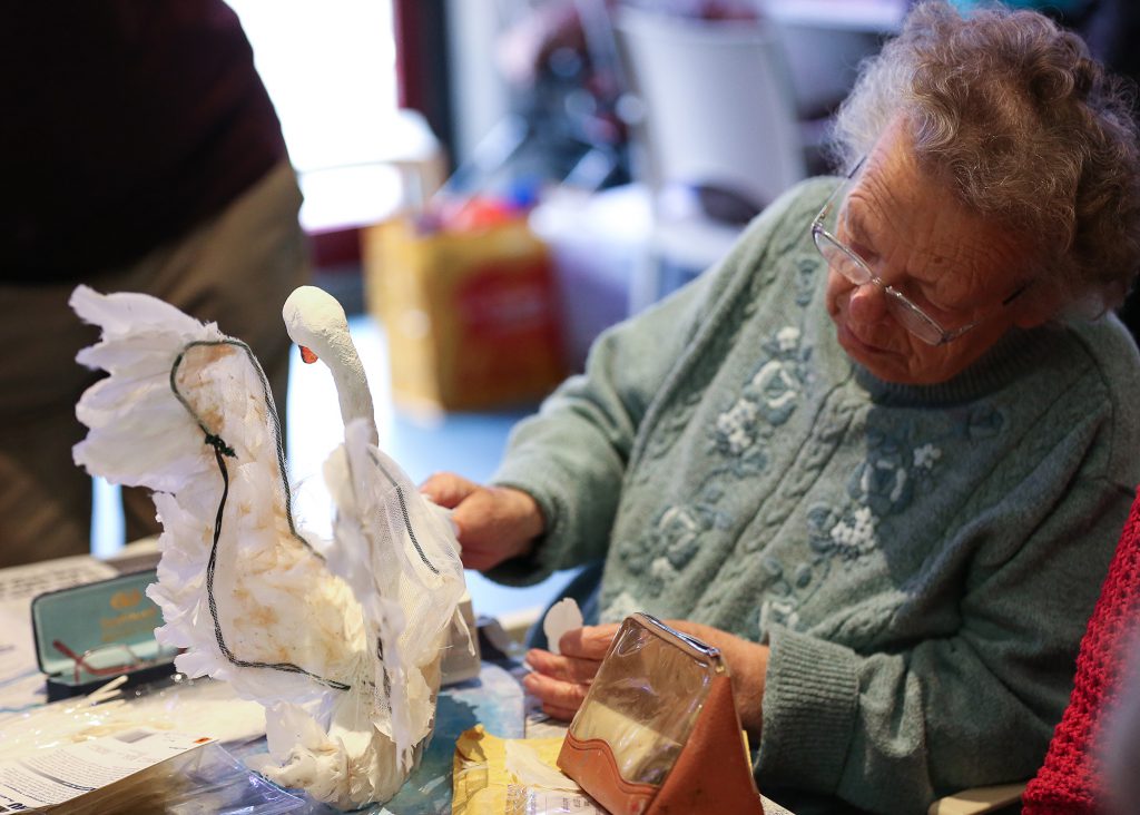 Woman crafting a paper swan