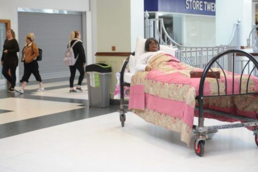 Actor in Bed in shopping centre
