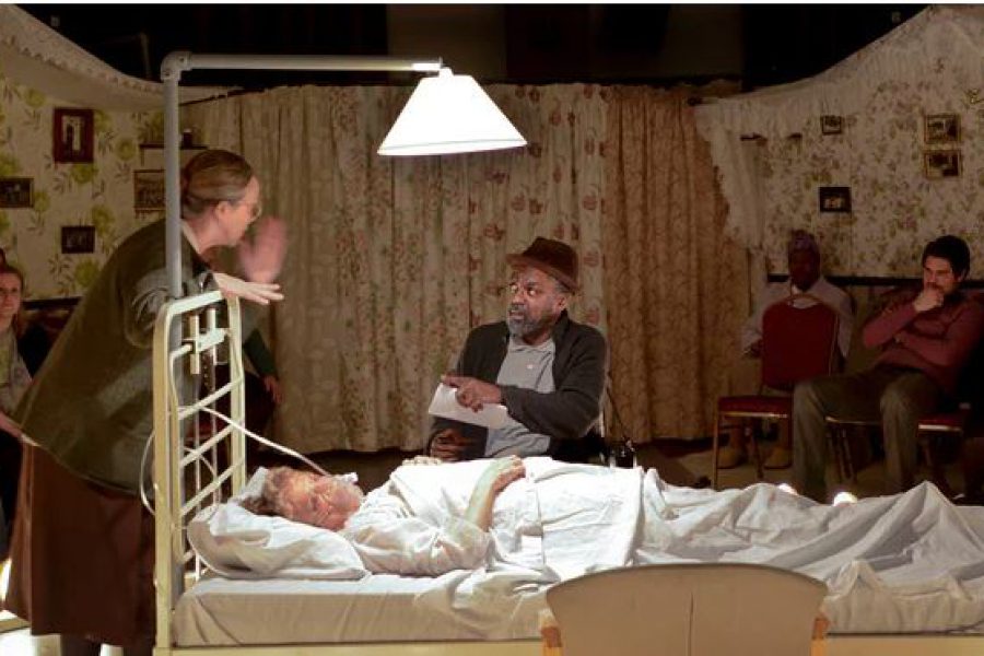 Bed with lamp over it people talking