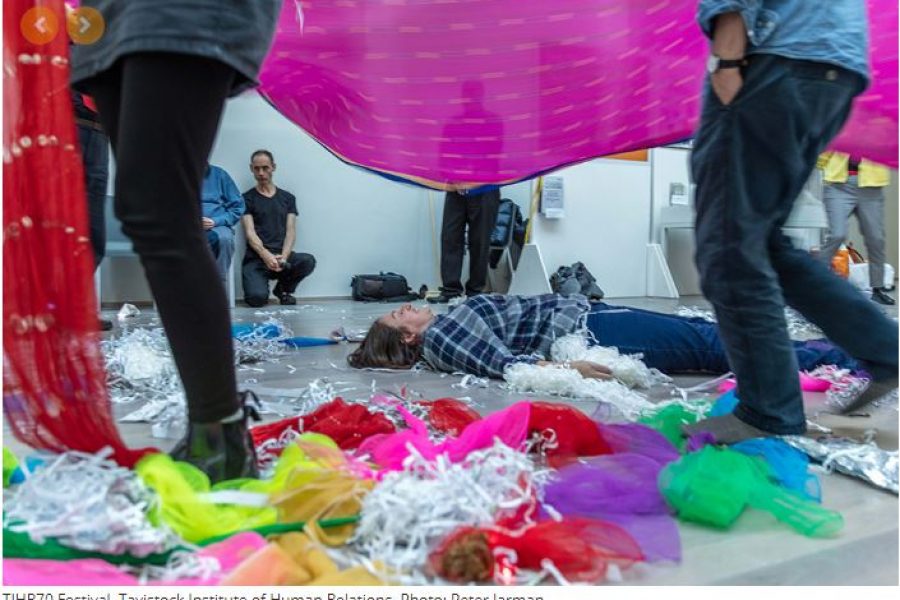 Coloured wool and cloth with people in and around it