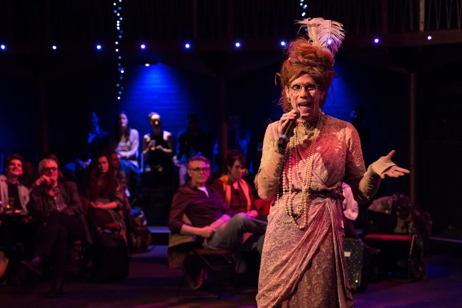 man dressed as women with microphone