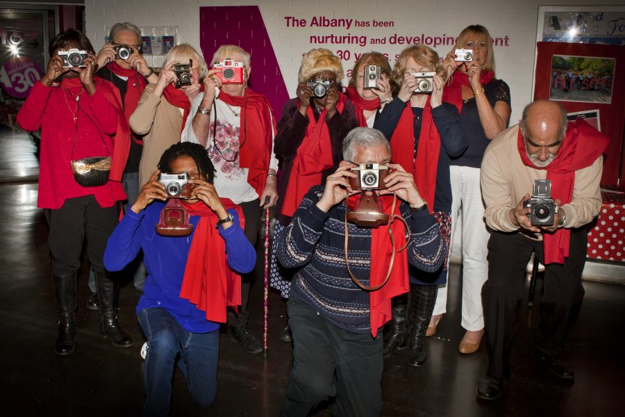 group of people looking at a camera through cameras