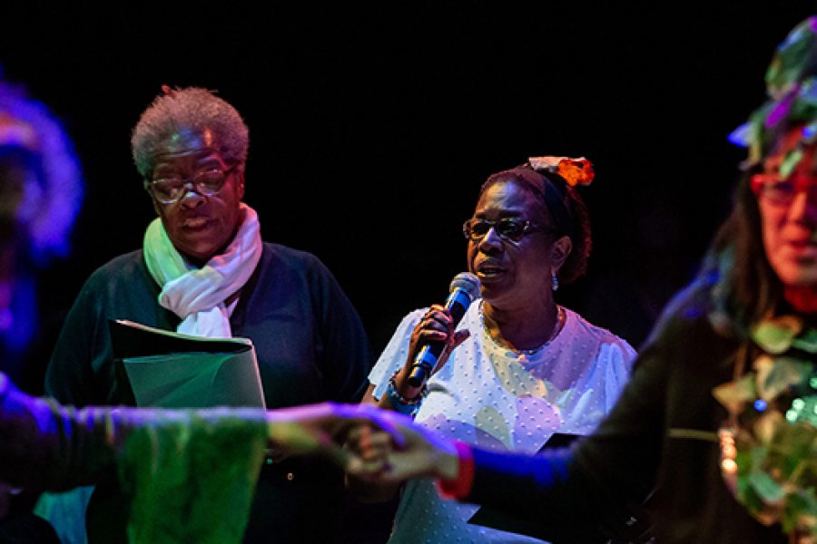 people on a stage talking on a microphone