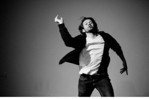 Black and white portrait of Cai Tomos moving