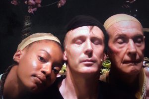 Portrait of one woman and two men eyes closed