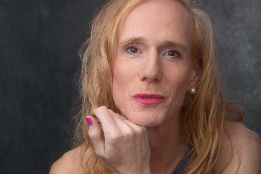A white woman with blonde hair and pink lipstick, pouting