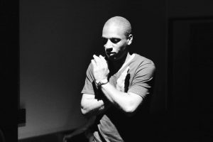 Portrait in black and white of Lee, a black man with a bald head
