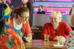 Two women at a table smiling