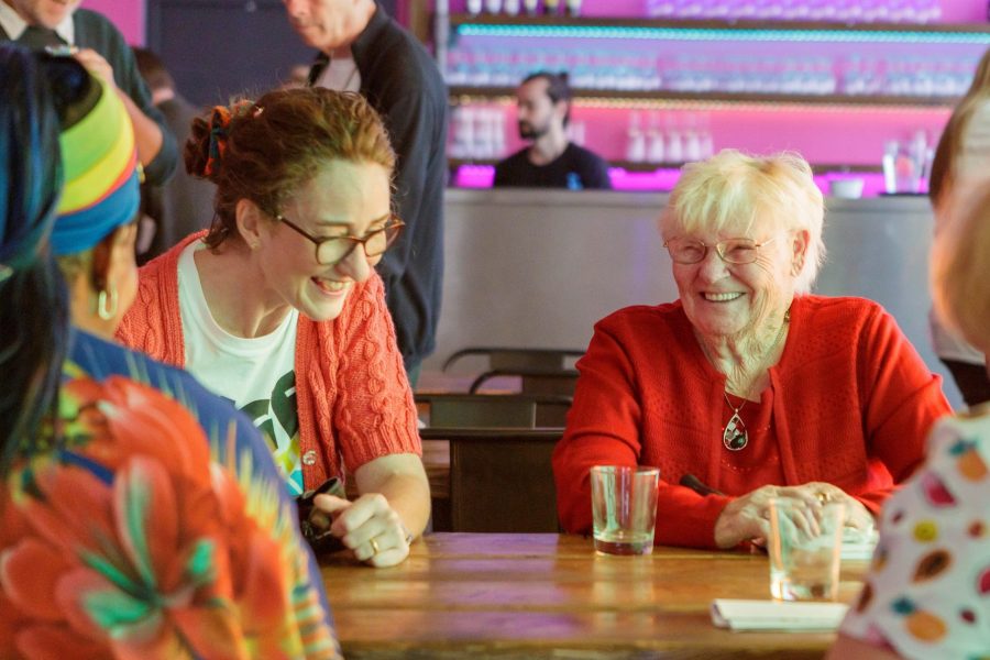 Two women at a table smiling