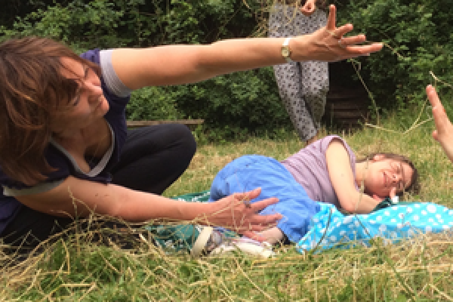 3 women lying on grass