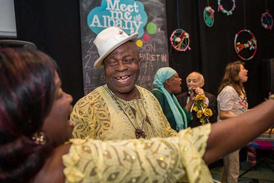 older man smiling with woman dancing