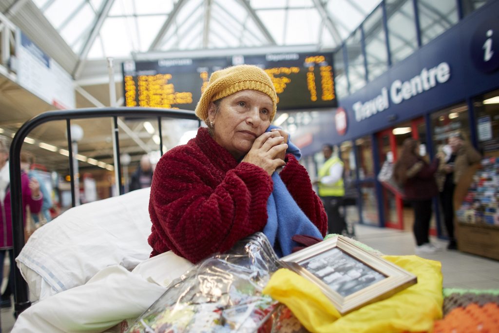 woman in bed in train station