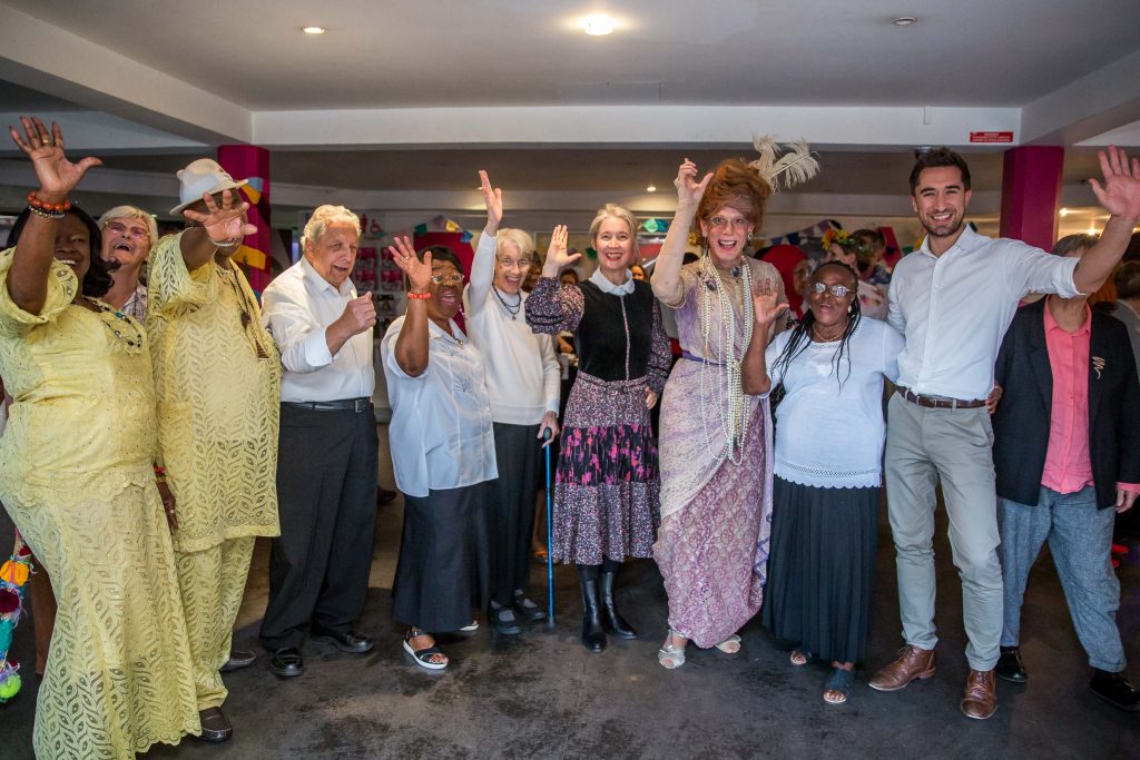 group of people waving to camera
