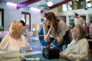 young woman talking to older women