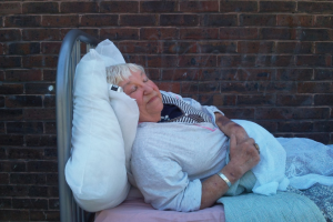 rosie in a bed with her eyes closed