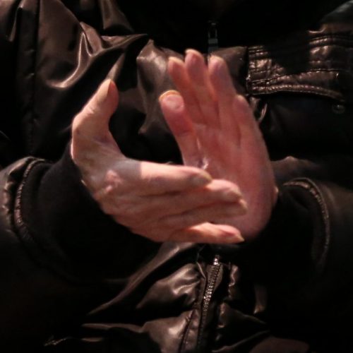 Man seated and clapping