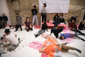 Group of people performing individually and together in a large room
