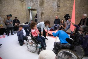 Group of people performing individually and together in a large room