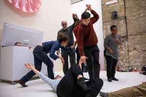 Group of people performing individually and together in a large room