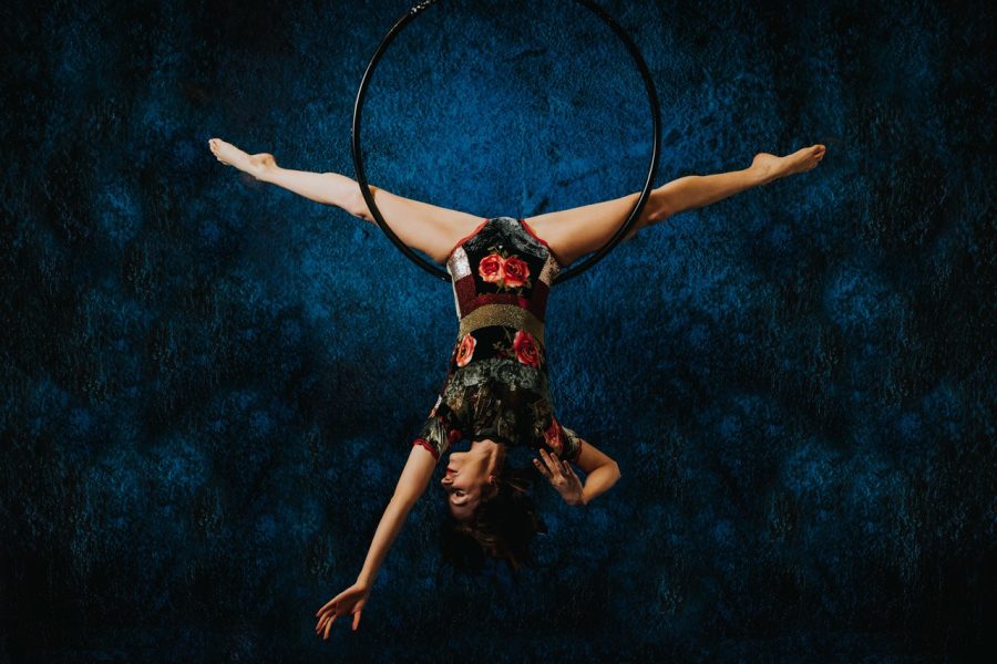 Woman doing acrobatics, suspended upside down from a hoop