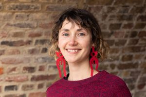 A portrait of a white woman with short dark hair