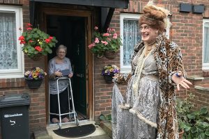 man dressed a woman on a doorstep visit