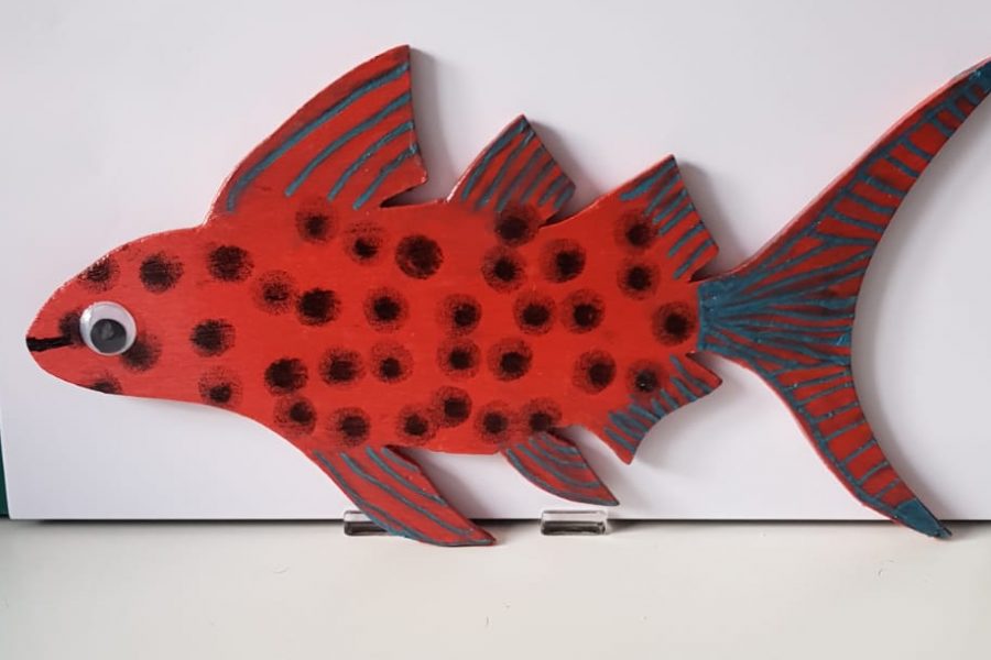 a fish made of wood and painted in bright colours