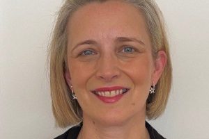 A portrait of Alison, a white woman with short light hair