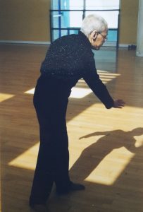 an older woman dancing with her back to the camera